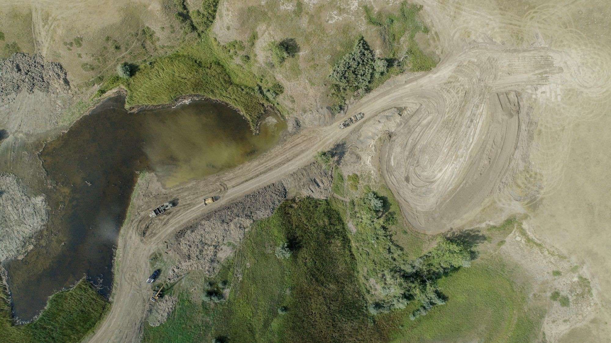 Aerial view of haul trucks moving material on a Black River job
